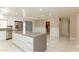 Open-concept kitchen with center island, stainless steel appliances, and tile flooring at 1403 5Th Pl, Las Vegas, NV 89104
