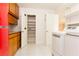 Bright laundry room with full-size washer, dryer, storage cabinets, and pantry at 1403 5Th Pl, Las Vegas, NV 89104