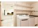 This bright laundry room features modern appliances, floating shelves, and easy access to the kitchen at 1403 5Th Pl, Las Vegas, NV 89104