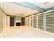 Spacious living room featuring custom built-in shelving, fireplace, tile flooring, and ceiling fan at 1403 5Th Pl, Las Vegas, NV 89104