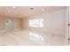 Bright living room with tiled floors, neutral walls, and a large window at 1403 5Th Pl, Las Vegas, NV 89104