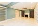 Large living room features a fireplace, built-in shelving, ceiling fan and a tile floor at 1403 5Th Pl, Las Vegas, NV 89104