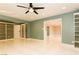 Bright living room featuring custom built-in shelving, ceiling fan, and light, glossy tile flooring at 1403 5Th Pl, Las Vegas, NV 89104