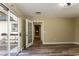 Bright living room features wood floors, neutral paint, open door, and sliding glass door to the outside at 1403 5Th Pl, Las Vegas, NV 89104