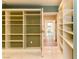 Living room with tile floors, built-in shelving and access to the bathroom and hallway at 1403 5Th Pl, Las Vegas, NV 89104