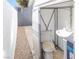 An outdoor toilet with a sink next to a gravel path enclosed with walls on each side at 1403 5Th Pl, Las Vegas, NV 89104