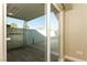 View of the home's private patio with concrete walls and covered overhang, as seen through the glass door at 1403 5Th Pl, Las Vegas, NV 89104
