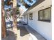 Exterior side view of charming white painted brick home featuring walkway and desert landscaping at 1403 5Th Pl, Las Vegas, NV 89104