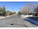 Wide neighborhood street with mature trees and clear skies at 1403 5Th Pl, Las Vegas, NV 89104