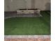 Landscaped backyard with artificial turf and stone planter at 2109 Juana Vista St, Las Vegas, NV 89102