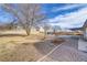 Gravel backyard space with mature trees and a covered patio, ideal for outdoor activities and enjoying the natural surroundings at 2121 Upland Ave, Pahrump, NV 89048