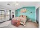 Bright bedroom featuring ensuite door to backyard, accent wall and ceiling fan at 2121 Upland Ave, Pahrump, NV 89048