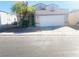 Single-story house with a white garage door and landscaping at 2132 Fred Brown Dr, Las Vegas, NV 89106