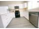 White kitchen with black appliances and gray flooring at 2132 Fred Brown Dr, Las Vegas, NV 89106