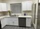 White kitchen cabinets, stainless steel appliances, and gray flooring at 2132 Fred Brown Dr, Las Vegas, NV 89106