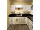 White kitchen with black countertops at 2528 Flower Ave, North Las Vegas, NV 89030