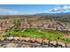 An aerial view of a vibrant residential neighborhood surrounding a golf course and green spaces at 2540 Youngdale Dr, Las Vegas, NV 89134