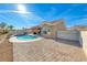 Wide angle of the backyard with sparkling pool and tiled patio at 2540 Youngdale Dr, Las Vegas, NV 89134