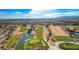 A scenic aerial view of the lush golf course with mature trees and water features and the city skyline in the distance at 2540 Youngdale Dr, Las Vegas, NV 89134