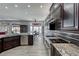 Modern kitchen with stainless steel appliances and granite countertops, adjacent to a dining area at 2540 Youngdale Dr, Las Vegas, NV 89134