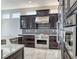 Gourmet kitchen featuring stainless steel appliances, granite countertops, and dark wood cabinets at 2540 Youngdale Dr, Las Vegas, NV 89134