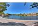 A serene lake view surrounded by lush greenery, walking paths, and attractive homes in the distance at 2540 Youngdale Dr, Las Vegas, NV 89134