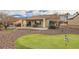 Expansive backyard with putting green, patio, and outdoor dining area at 2608 Dearport Ct, Henderson, NV 89052