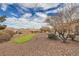 Beautiful backyard with putting green, decorative rocks, and desert landscaping at 2608 Dearport Ct, Henderson, NV 89052