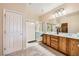 Elegant bathroom with double sinks, wood cabinets, and a shower at 2608 Dearport Ct, Henderson, NV 89052