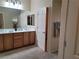 Bright bathroom features double sinks, wood cabinets, and large mirror at 2608 Dearport Ct, Henderson, NV 89052