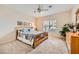 Spacious bedroom with wood furniture and a ceiling fan at 2608 Dearport Ct, Henderson, NV 89052