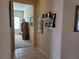 Inviting hallway featuring decorative wall shelves and view of the living room at 2608 Dearport Ct, Henderson, NV 89052