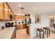 Well-lit kitchen featuring tile flooring, wooden cabinetry, and stainless steel appliances at 2608 Dearport Ct, Henderson, NV 89052