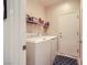 Convenient laundry room equipped with a washer, dryer, and overhead shelf at 2608 Dearport Ct, Henderson, NV 89052