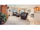 Spacious living room featuring leather furniture and a neutral color scheme at 2608 Dearport Ct, Henderson, NV 89052