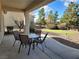 Covered patio with outdoor seating area overlooking the putting green and backyard at 2608 Dearport Ct, Henderson, NV 89052