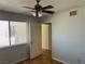 Bedroom featuring natural light from a window, a ceiling fan, and an entrance to the hall at 2679 Jacyra Ave, Las Vegas, NV 89121