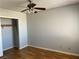 A simple bedroom with light gray walls, a ceiling fan, and a closet with shelving at 2679 Jacyra Ave, Las Vegas, NV 89121
