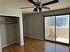 Bright bedroom features wood floors, fan, closet, and sliding glass doors to balcony at 2679 Jacyra Ave, Las Vegas, NV 89121