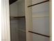 A bedroom closet featuring multiple levels of wooden rods for maximum hanging storage at 2679 Jacyra Ave, Las Vegas, NV 89121