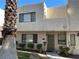 Tan two-story stucco townhouse with mature landscaping and a private entrance at 2679 Jacyra Ave, Las Vegas, NV 89121