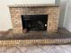 Close up of a brick fireplace with a black metal screen at 2679 Jacyra Ave, Las Vegas, NV 89121