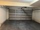 View of the empty two car garage with grey door at 2679 Jacyra Ave, Las Vegas, NV 89121