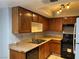 A kitchen with wood cabinets, stainless steel appliances, and tile flooring at 2679 Jacyra Ave, Las Vegas, NV 89121