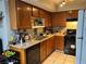 Galley kitchen with wood cabinets, and a full suite of appliances at 2679 Jacyra Ave, Las Vegas, NV 89121