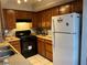 Efficient kitchen featuring wood cabinets, gas range, and refrigerator at 2679 Jacyra Ave, Las Vegas, NV 89121