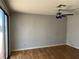 Bright living room with light gray walls, a fan, and sliding glass doors to the outside at 2679 Jacyra Ave, Las Vegas, NV 89121