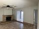 A living room featuring a brick fireplace, tile flooring, and a view to another room at 2679 Jacyra Ave, Las Vegas, NV 89121