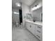 Bathroom featuring double sinks, granite countertops, white cabinets, and modern lighting at 2700 W Carnation Way, Pahrump, NV 89048