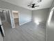 Spacious bedroom featuring modern ceiling fan, light gray walls, and walk-in closet at 2700 W Carnation Way, Pahrump, NV 89048